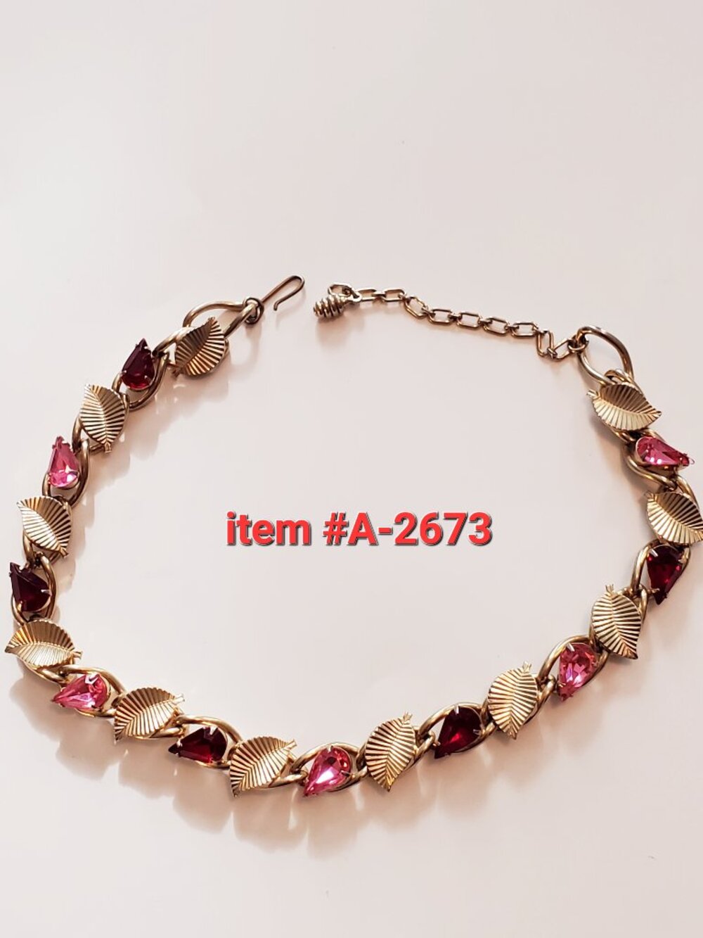 1 Gold Necklace with pink & red gem stones, item # A 2673, .wt 52 grams.